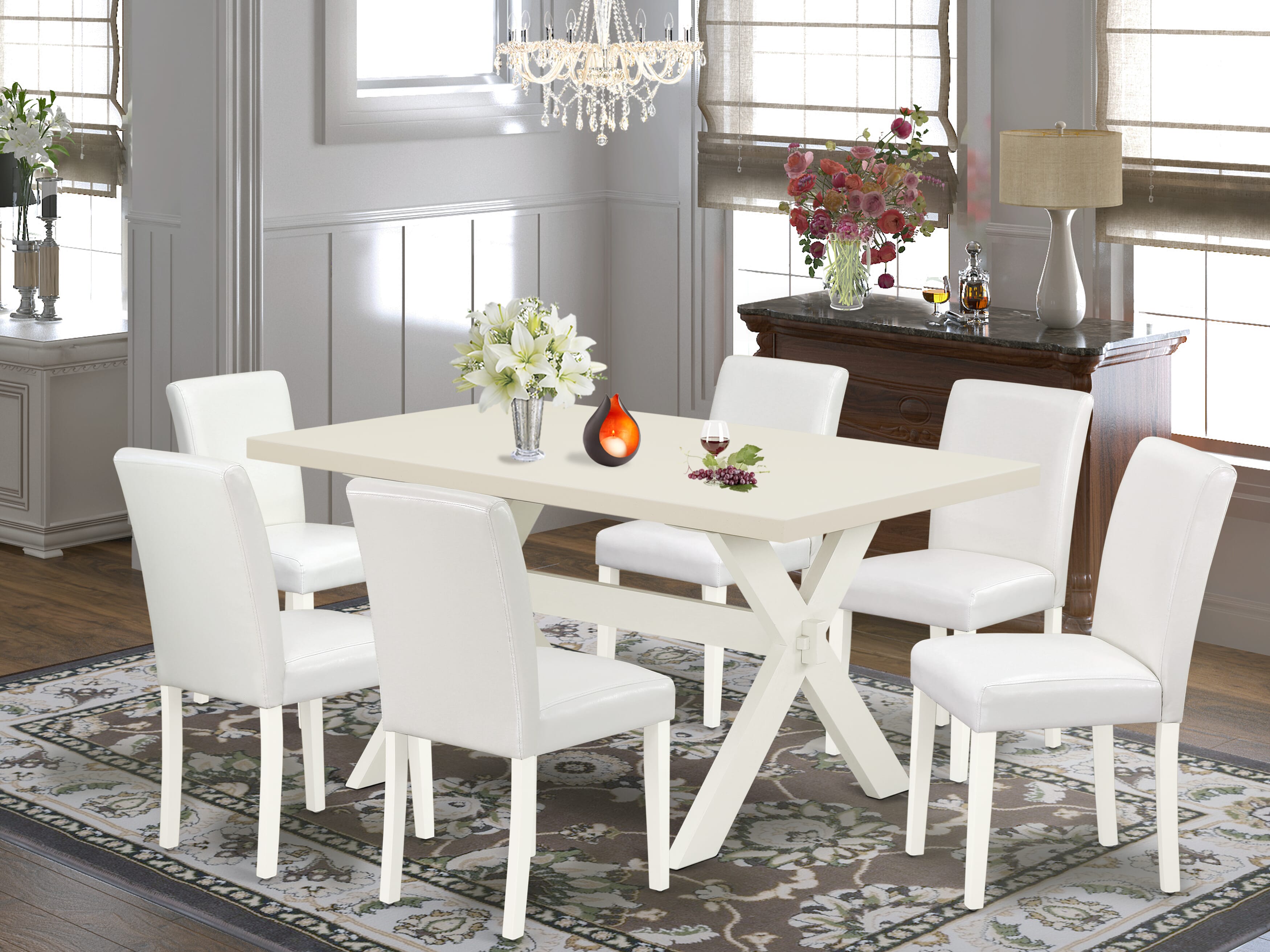 Juego de mesa de cocina de 7 piezas East West Furniture X026AB264-7 compuesto por una mesa de comedor rectangular con patas en forma de X y 6 sillas de comedor Parsons de piel sintética blanca.