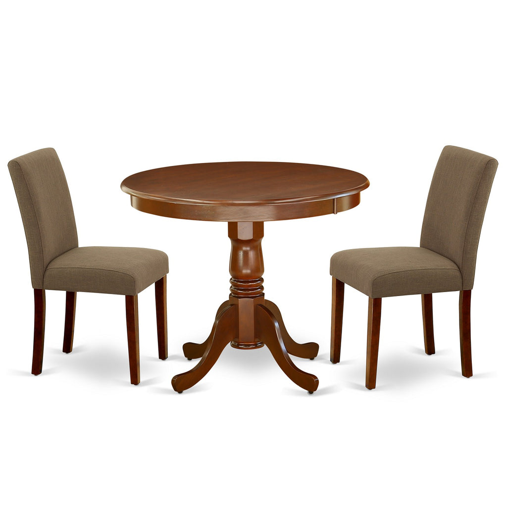 Juego de mesa de comedor moderna de 3 piezas East West Furniture ANAB3-MAH-18. Incluye una mesa de cocina redonda con pedestal y dos sillas de comedor Parson de tela de lino color café.