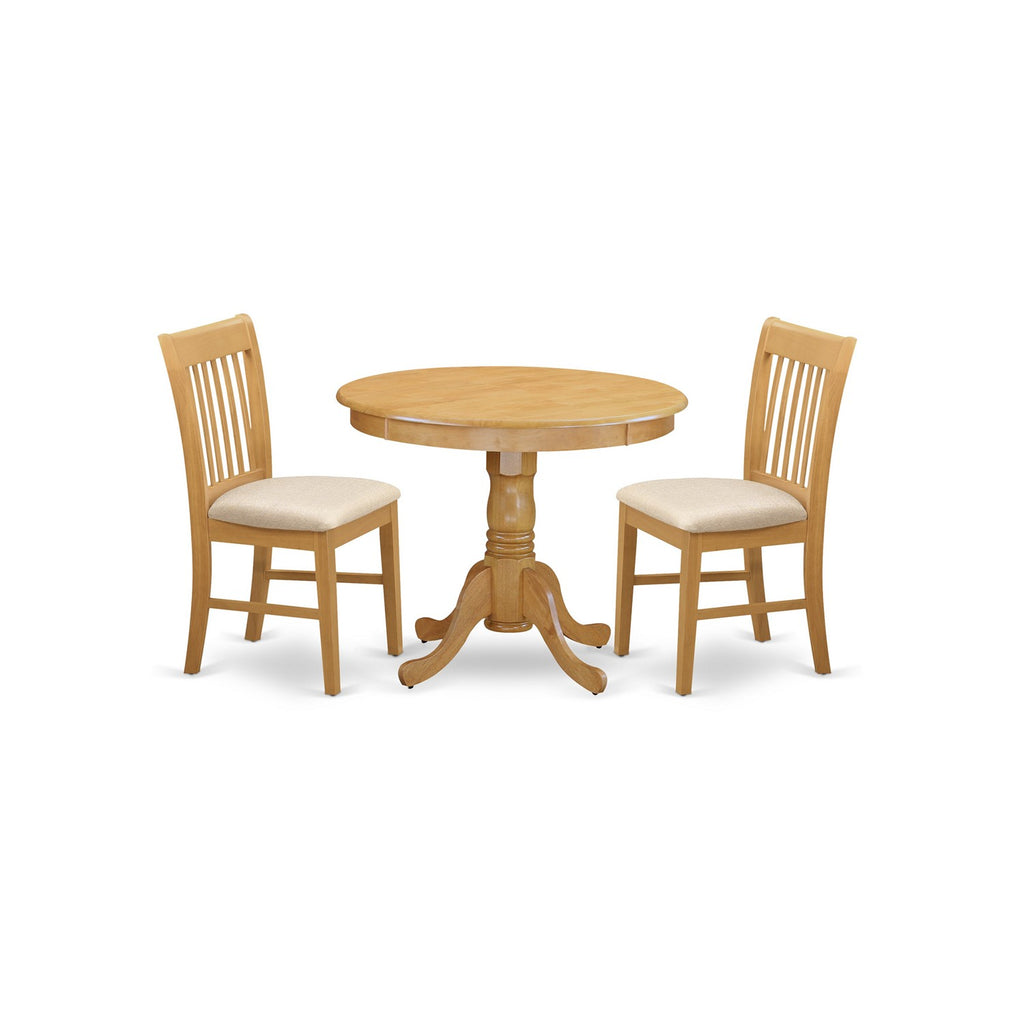 Juego de mesa de cocina de 3 piezas East West Furniture ANNO3-OAK-C para espacios pequeños. Contiene una mesa de comedor redonda con pedestal y 2 sillas tapizadas en tela de lino.